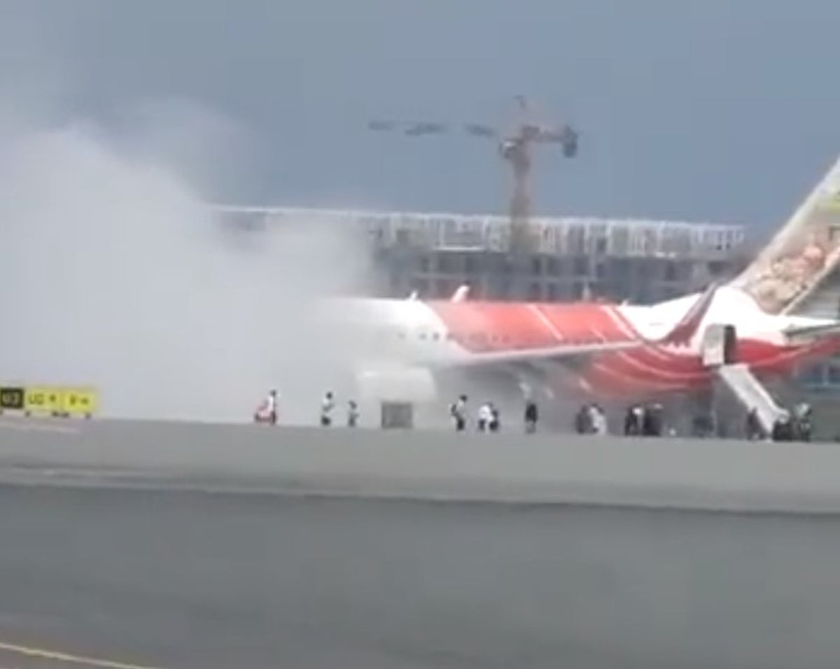 Smoke pours from Air India flight as passengers rush to evacuate